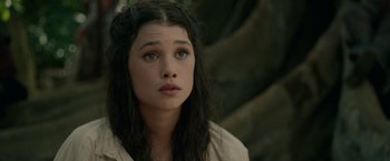 Movie still from “Pirates of the Caribbean: On Stranger Tides” (2011), directed by Rob Marshall – A young woman with long black hair and green eyes looking to her left; Close Up shot, High angle