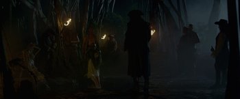 Movie still from “Pirates of the Caribbean: On Stranger Tides” (2011), directed by Rob Marshall – A group of people standing in the woods at night; Wide shot, Over the shoulder angle