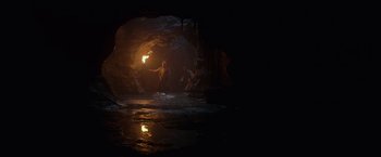 Movie still from “Pirates of the Caribbean: On Stranger Tides” (2011), directed by Rob Marshall – A man is standing in a cave with a fire; Extreme Wide shot, High angle