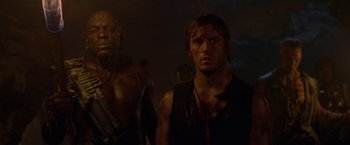 Movie still from “Pirates of the Caribbean: On Stranger Tides” (2011), directed by Rob Marshall – A man standing next to another man in a dark room; Close Up shot, Low angle