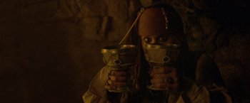 Movie still from “Pirates of the Caribbean: On Stranger Tides” (2011), directed by Rob Marshall – A woman in a pirate costume holding two cups; Close Up shot, High angle