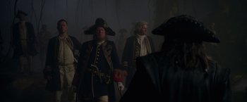 Movie still from “Pirates of the Caribbean: On Stranger Tides” (2011), directed by Rob Marshall – A group of men in period costumes walking in a dark room; Medium shot, Over the shoulder angle