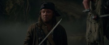 Movie still from “Pirates of the Caribbean: On Stranger Tides” (2011), directed by Rob Marshall – A man in a pirate costume holding a sword; Close Up shot, Low angle