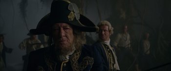 Movie still from “Pirates of the Caribbean: On Stranger Tides” (2011), directed by Rob Marshall – A man in a pirate hat and a man in a wig; Close Up shot, Low angle