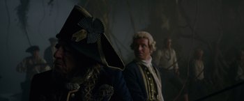 Movie still from “Pirates of the Caribbean: On Stranger Tides” (2011), directed by Rob Marshall – A man in a pirate costume and a man in a pirate outfit; Close Up shot, Over the shoulder angle