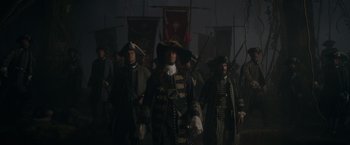 Movie still from “Pirates of the Caribbean: On Stranger Tides” (2011), directed by Rob Marshall – A group of people in costumes are standing together; Wide shot, Low angle