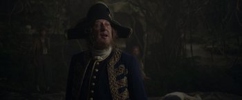 Movie still from “Pirates of the Caribbean: On Stranger Tides” (2011), directed by Rob Marshall – A man wearing a pirate hat and a blue coat; Medium shot, Low angle