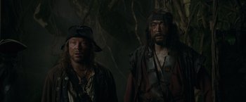 Movie still from “Pirates of the Caribbean: On Stranger Tides” (2011), directed by Rob Marshall – Two men dressed as pirates in the woods; Medium shot, Low angle