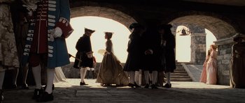 Movie still from “Pirates of the Caribbean: The Curse of the Black Pearl” (2003), directed by Gore Verbinski – A group of people dressed in period clothing; Wide shot, Low angle