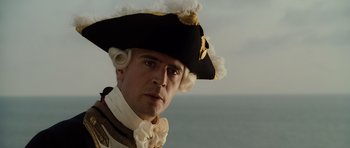 Movie still from “Pirates of the Caribbean: The Curse of the Black Pearl” (2003), directed by Gore Verbinski – A person wearing a hat; Close Up shot, Low angle