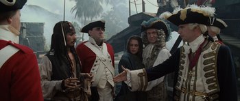 Movie still from “Pirates of the Caribbean: The Curse of the Black Pearl” (2003), directed by Gore Verbinski – A group of people dressed in pirate costumes; Medium shot, Over the shoulder angle