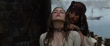 Movie still from “Pirates of the Caribbean: The Curse of the Black Pearl” (2003), directed by Gore Verbinski – A woman with a chain around her neck and a man with a pirate's beard; Close Up shot, Over the shoulder angle