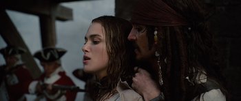 Movie still from “Pirates of the Caribbean: The Curse of the Black Pearl” (2003), directed by Gore Verbinski – A woman with long hair and a man with long hair; Close Up shot, Over the shoulder angle