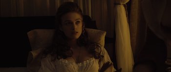 Movie still from “Pirates of the Caribbean: The Curse of the Black Pearl” (2003), directed by Gore Verbinski – A beautiful young lady sitting on a bed; Close Up shot, High angle