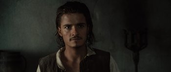 Movie still from “Pirates of the Caribbean: The Curse of the Black Pearl” (2003), directed by Gore Verbinski – A man with long black hair and a mustache; Close Up shot, Low angle