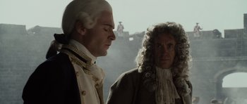 Movie still from “Pirates of the Caribbean: The Curse of the Black Pearl” (2003), directed by Gore Verbinski – A man and a woman in historical dress looking at each other; Medium shot, Over the shoulder angle