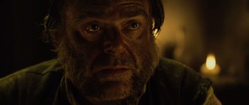 Movie still from “Pirates of the Caribbean: The Curse of the Black Pearl” (2003), directed by Gore Verbinski – A person with a beard looking at the camera; Close Up shot, Over the shoulder angle