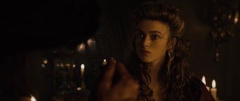 Movie still from “Pirates of the Caribbean: The Curse of the Black Pearl” (2003), directed by Gore Verbinski – A young woman is holding a pen in her right hand; Close Up shot, Over the shoulder angle