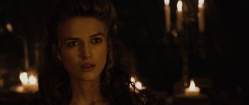 Movie still from “Pirates of the Caribbean: The Curse of the Black Pearl” (2003), directed by Gore Verbinski – A beautiful woman with long hair standing in a dark room; Close Up shot, Over the shoulder angle