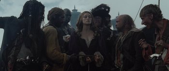 Movie still from “Pirates of the Caribbean: The Curse of the Black Pearl” (2003), directed by Gore Verbinski – A group of people standing next to each other; Medium shot, Over the shoulder angle