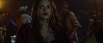 Movie still from “Pirates of the Caribbean: The Curse of the Black Pearl” (2003), directed by Gore Verbinski – A beautiful young lady with long brown hair wearing a necklace; Close Up shot, Over the shoulder angle