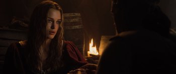 Movie still from “Pirates of the Caribbean: The Curse of the Black Pearl” (2003), directed by Gore Verbinski – A woman sitting next to a man in front of a fireplace; Close Up shot, Over the shoulder angle