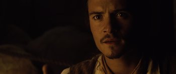 Movie still from “Pirates of the Caribbean: The Curse of the Black Pearl” (2003), directed by Gore Verbinski – A person with a beard looking at the camera; Close Up shot, High angle