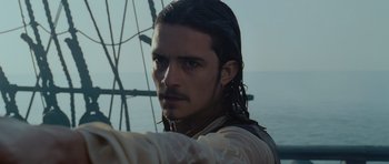 Movie still from “Pirates of the Caribbean: The Curse of the Black Pearl” (2003), directed by Gore Verbinski – A person with long hair on a boat; Close Up shot, Over the shoulder angle