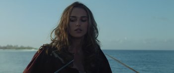 Movie still from “Pirates of the Caribbean: The Curse of the Black Pearl” (2003), directed by Gore Verbinski – A beautiful woman with long brown hair standing next to the ocean; Close Up shot, Over the shoulder angle