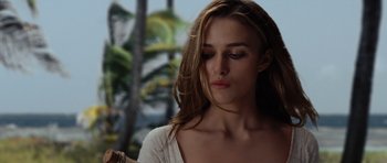 Movie still from “Pirates of the Caribbean: The Curse of the Black Pearl” (2003), directed by Gore Verbinski – A beautiful young woman with long brown hair and wearing a white shirt; Close Up shot, Over the shoulder angle