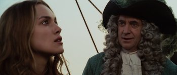 Movie still from “Pirates of the Caribbean: The Curse of the Black Pearl” (2003), directed by Gore Verbinski – A man and a woman are standing next to each other; Close Up shot, Over the shoulder angle