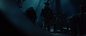 Movie still from “Pirates of the Caribbean: The Curse of the Black Pearl” (2003), directed by Gore Verbinski – A group of people dressed as pirates walking on a dock; Wide shot, Low angle