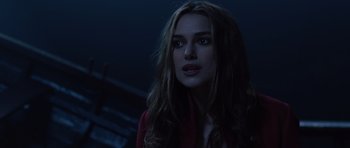 Movie still from “Pirates of the Caribbean: The Curse of the Black Pearl” (2003), directed by Gore Verbinski – A beautiful young woman with long , wavy hair wearing a red jacket; Close Up shot, Over the shoulder angle