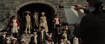 Movie still from “Pirates of the Caribbean: The Curse of the Black Pearl” (2003), directed by Gore Verbinski – A group of people dressed in period clothing; Medium shot, Over the shoulder angle