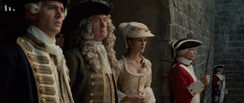 Movie still from “Pirates of the Caribbean: The Curse of the Black Pearl” (2003), directed by Gore Verbinski – A man and a woman dressed in period clothing; Medium shot, Low angle