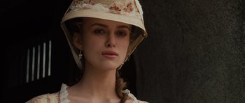 Movie still from “Pirates of the Caribbean: The Curse of the Black Pearl” (2003), directed by Gore Verbinski – A woman wearing a hat and a dress; Close Up shot, Low angle