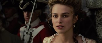 Movie still from “Pirates of the Caribbean: The Curse of the Black Pearl” (2003), directed by Gore Verbinski – A person wearing a dress and holding an umbrella; Close Up shot, Over the shoulder angle