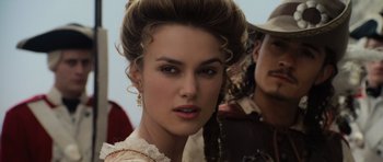 Movie still from “Pirates of the Caribbean: The Curse of the Black Pearl” (2003), directed by Gore Verbinski – A person wearing a hat; Close Up shot, Over the shoulder angle