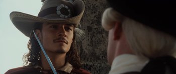 Movie still from “Pirates of the Caribbean: The Curse of the Black Pearl” (2003), directed by Gore Verbinski – A person wearing a hat; Close Up shot, Over the shoulder angle