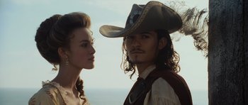 Movie still from “Pirates of the Caribbean: The Curse of the Black Pearl” (2003), directed by Gore Verbinski – A man and a woman standing next to each other; Close Up shot, Low angle