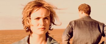 Movie still from “Pitch Black” (2000), directed by David Twohy – A woman's face in a desert setting; Close Up shot, Over the shoulder angle