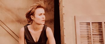 Movie still from “Pitch Black” (2000), directed by David Twohy – A woman in a black shirt is looking to the side; Close Up shot, Low angle