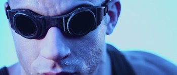 Movie still from “Pitch Black” (2000), directed by David Twohy – A person wearing sunglasses; Extreme Close Up shot, Low angle