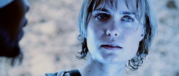 Movie still from “Pitch Black” (2000), directed by David Twohy – A person's face in a blue light; Close Up shot, Low angle