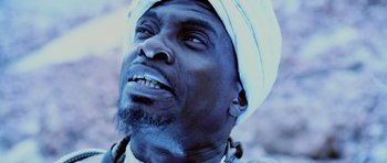 Movie still from “Pitch Black” (2000), directed by David Twohy – A person wearing a turban; Close Up shot, Low angle