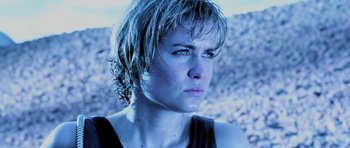 Movie still from “Pitch Black” (2000), directed by David Twohy – A person with wet hair; Close Up shot, Low angle