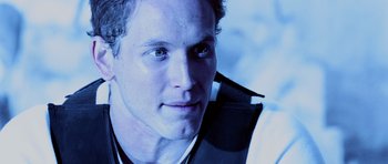 Movie still from “Pitch Black” (2000), directed by David Twohy – A person wearing a vest; Close Up shot, Over the shoulder angle