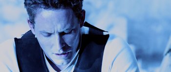 Movie still from “Pitch Black” (2000), directed by David Twohy – A person wearing a jacket; Close Up shot, Low angle