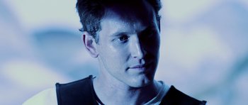 Movie still from “Pitch Black” (2000), directed by David Twohy – A man's face in blue light; Close Up shot, Low angle