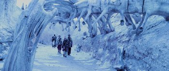 Movie still from “Pitch Black” (2000), directed by David Twohy – A group of people walking on a snowy path; Extreme Wide shot, Low angle